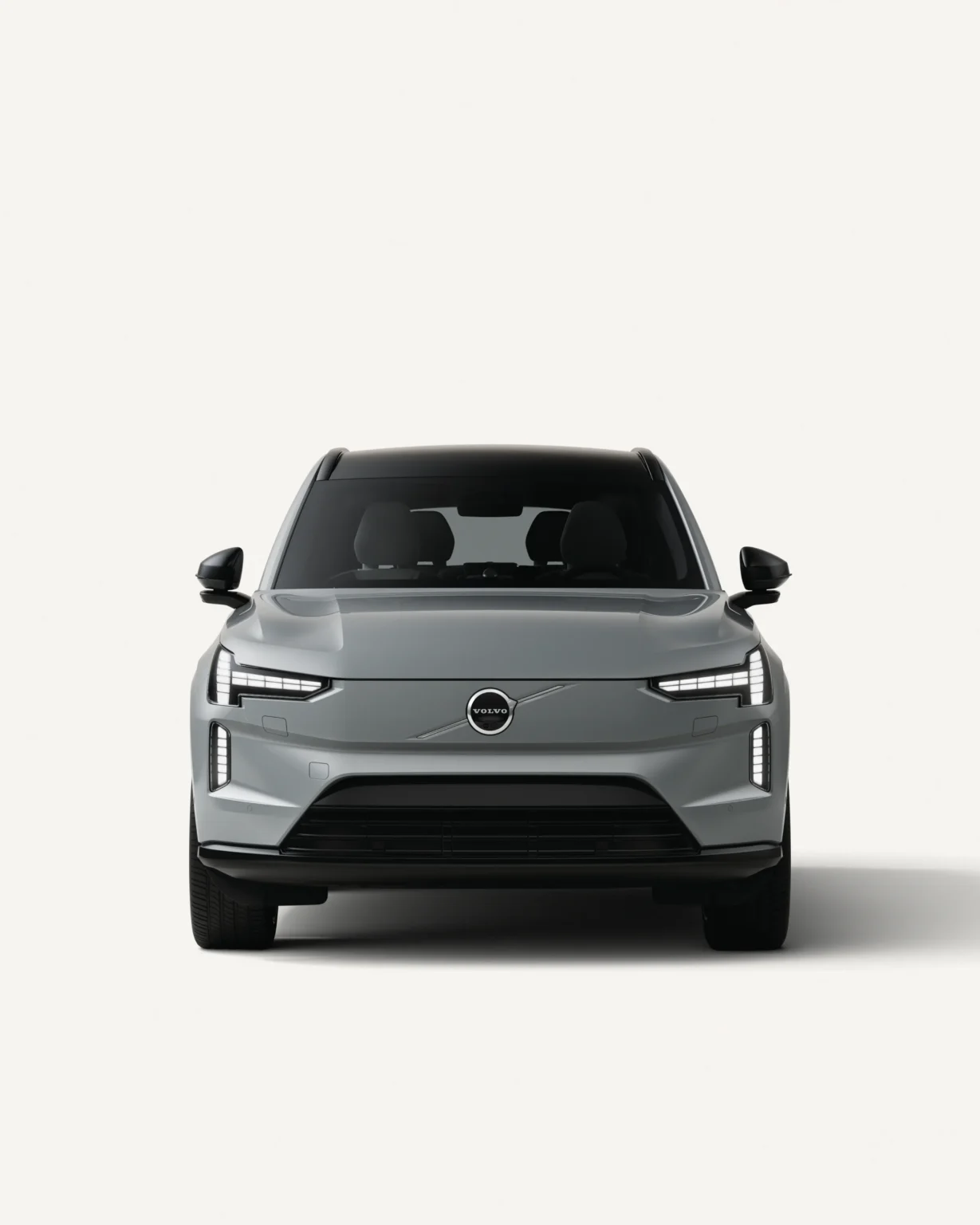 Grey Volvo EX90 seen from the front in a white studio