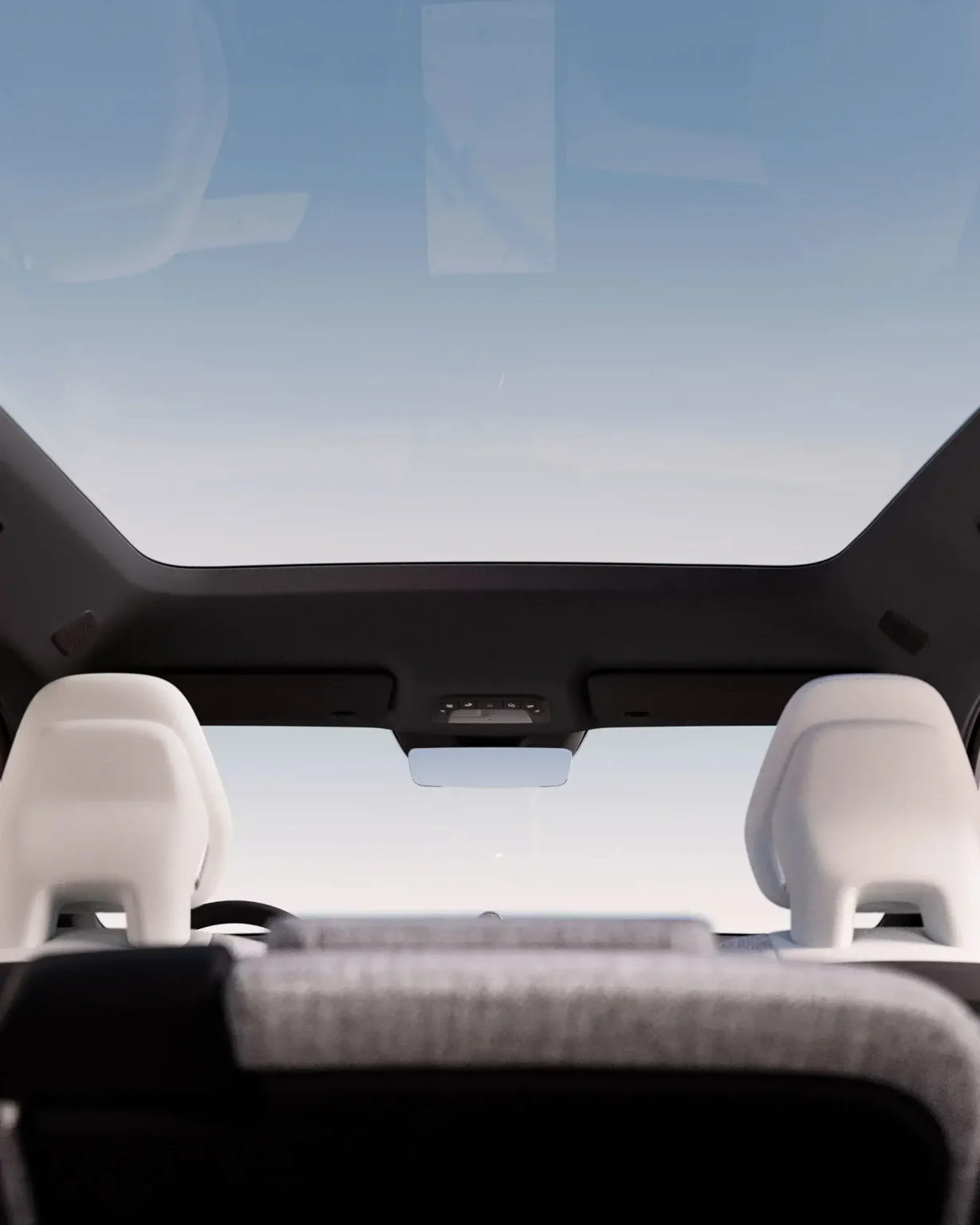 View up through the Volvo EX90 panoramic glass roof above light-coloured seats
