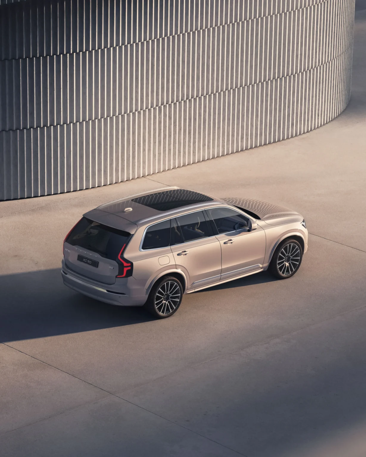 Volvo XC90 from a high rear three-quarter angle, showing its panoramic roof