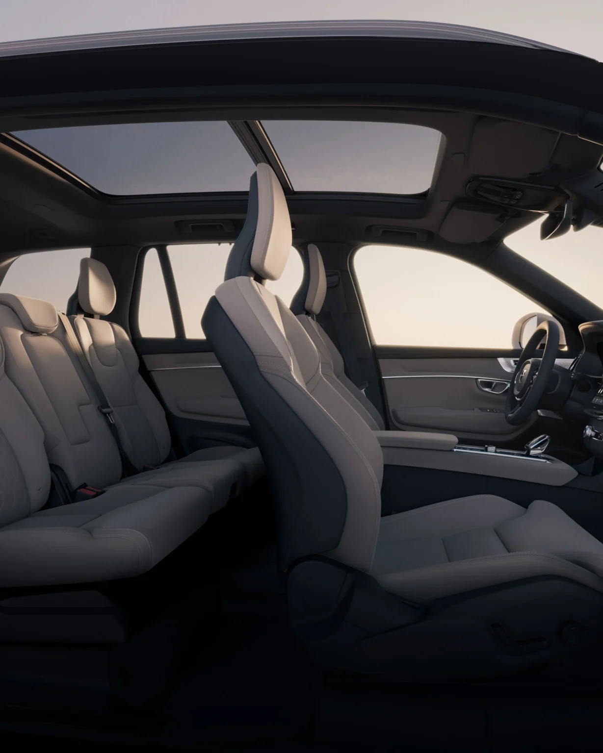 Front and second-row seats of the Volvo XC90 seen through the open doors, under the panoramic roof