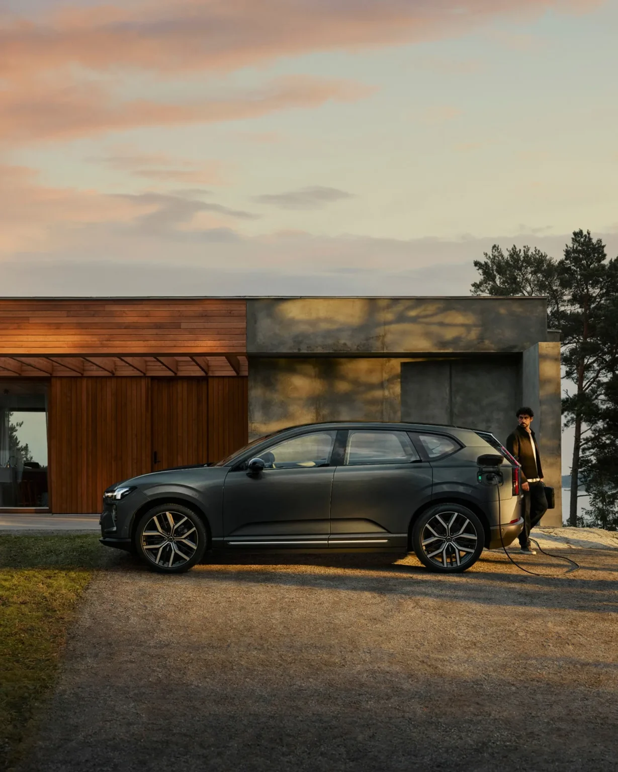 Volvo EX60 charging outside a modern house