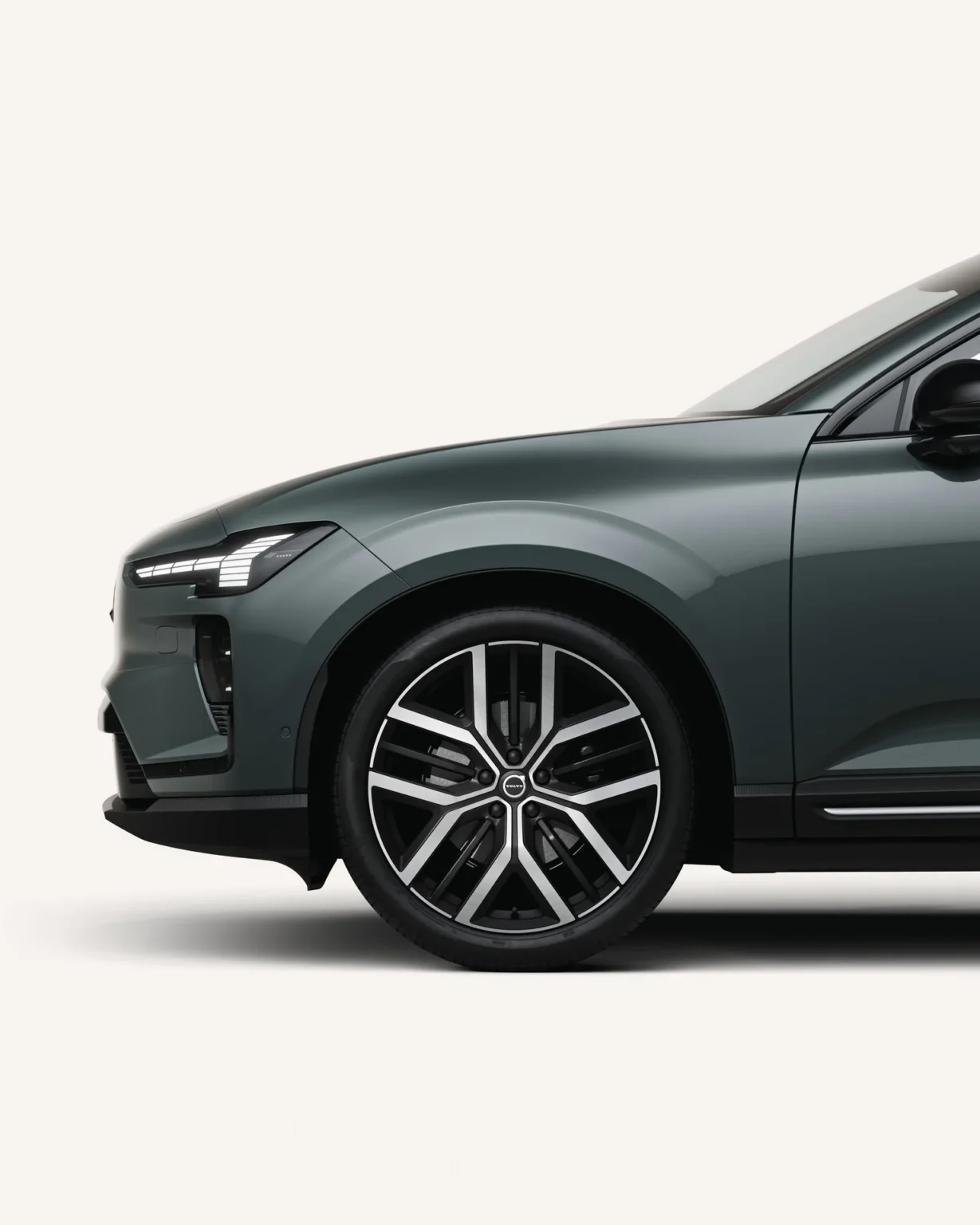Front wheel and side profile of a Volvo EX60 in a white studio