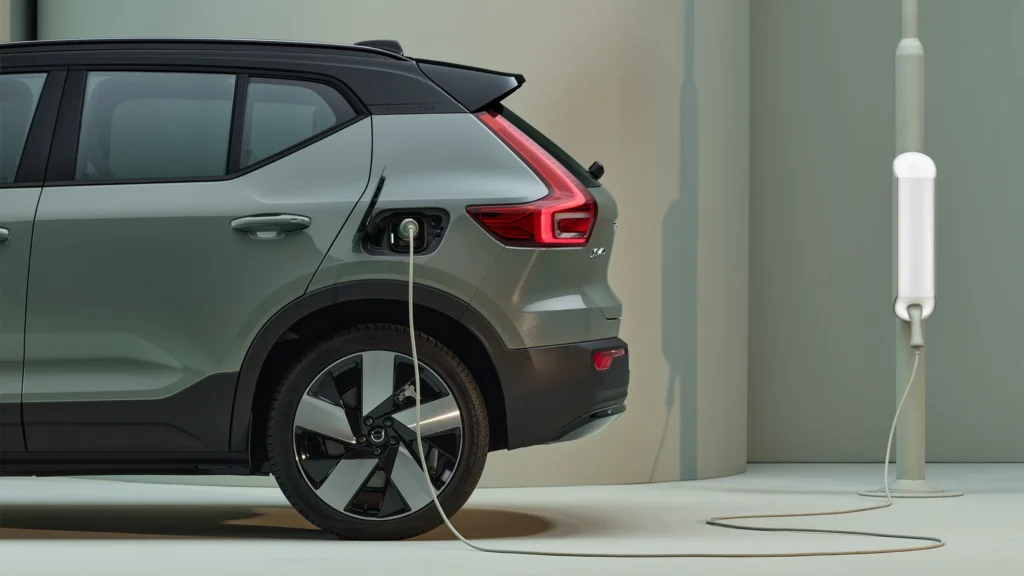 Rear wheel of a Volvo XC40 Recharge with the charging cable connected