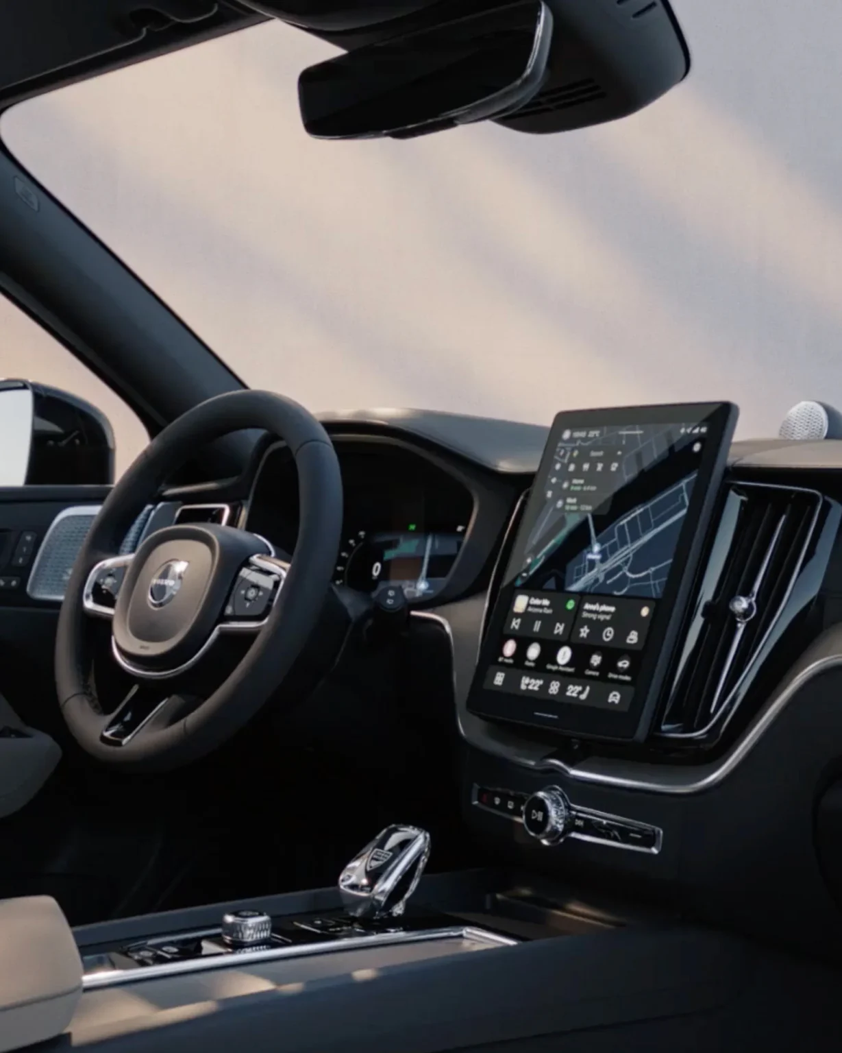 Volvo XC60 cockpit with the steering wheel, driver display and portrait centre touchscreen