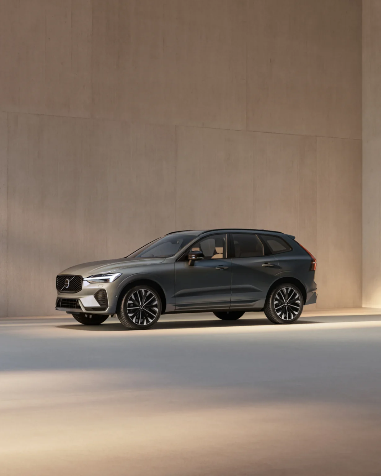 Volvo XC60 from the front three-quarter in a sunlit concrete space