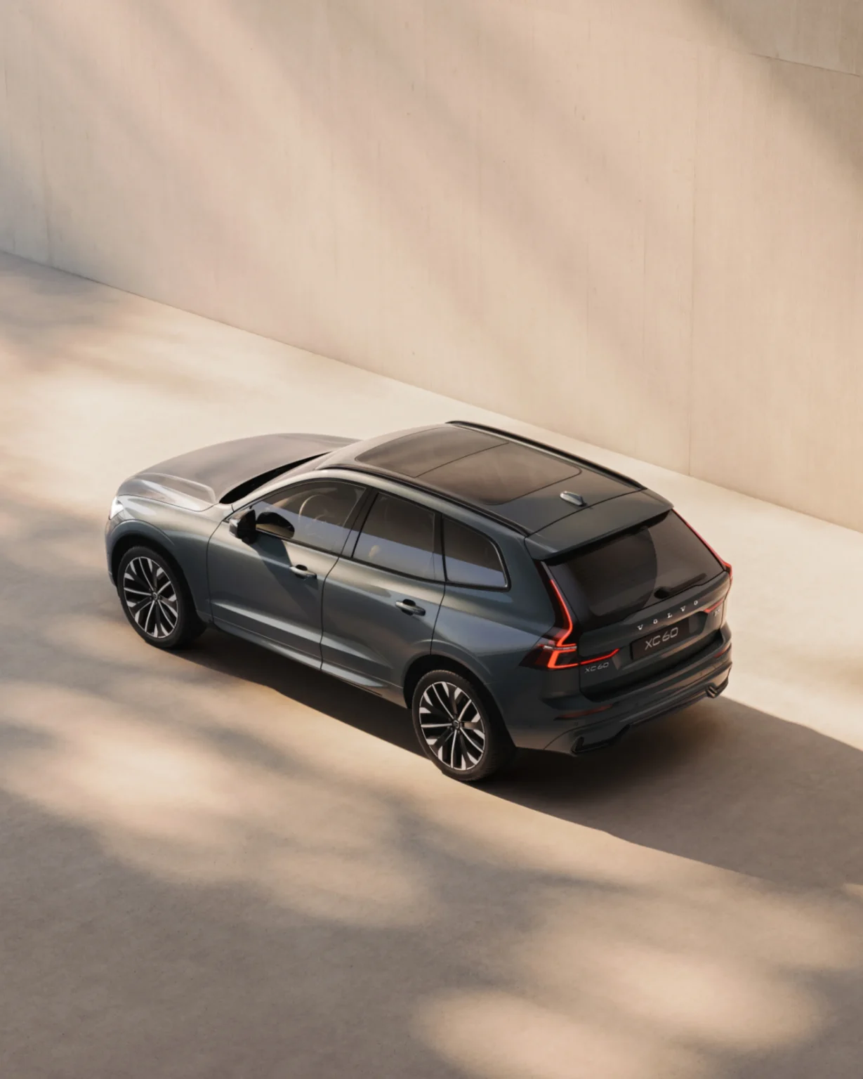 Volvo XC60 from a high rear three-quarter angle, showing its panoramic roof