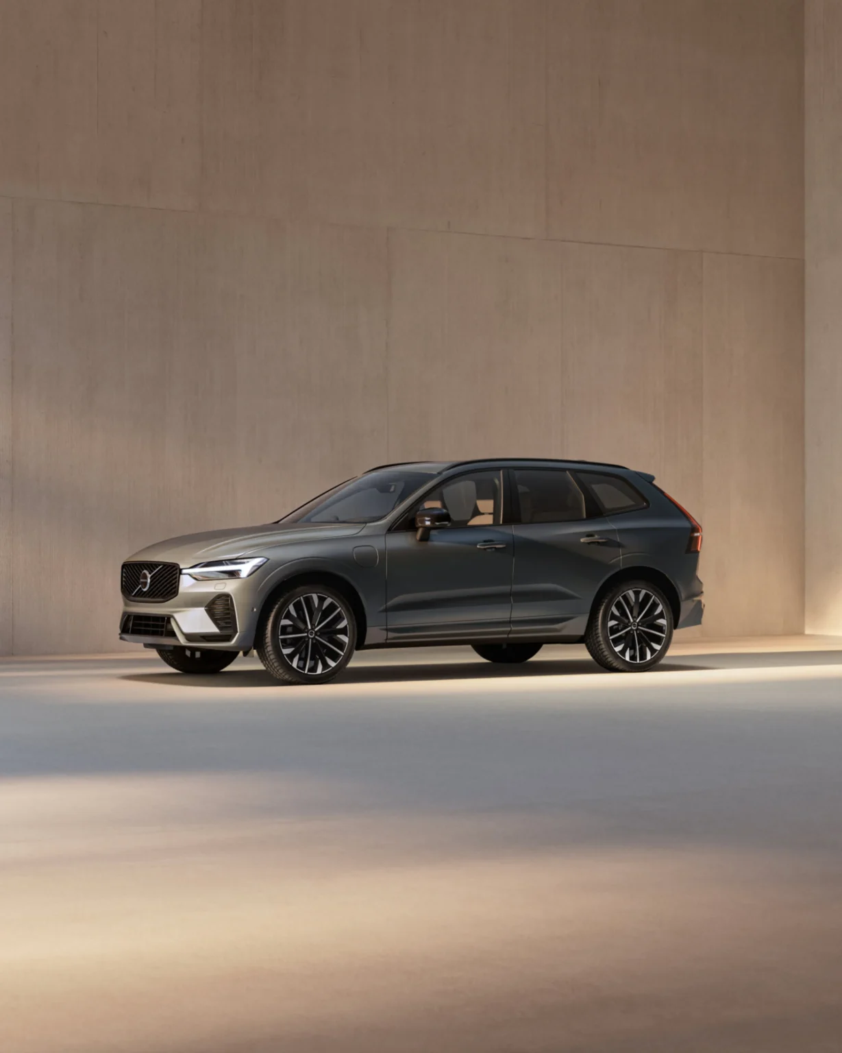 Volvo XC60 from the front three-quarter in a sunlit concrete space