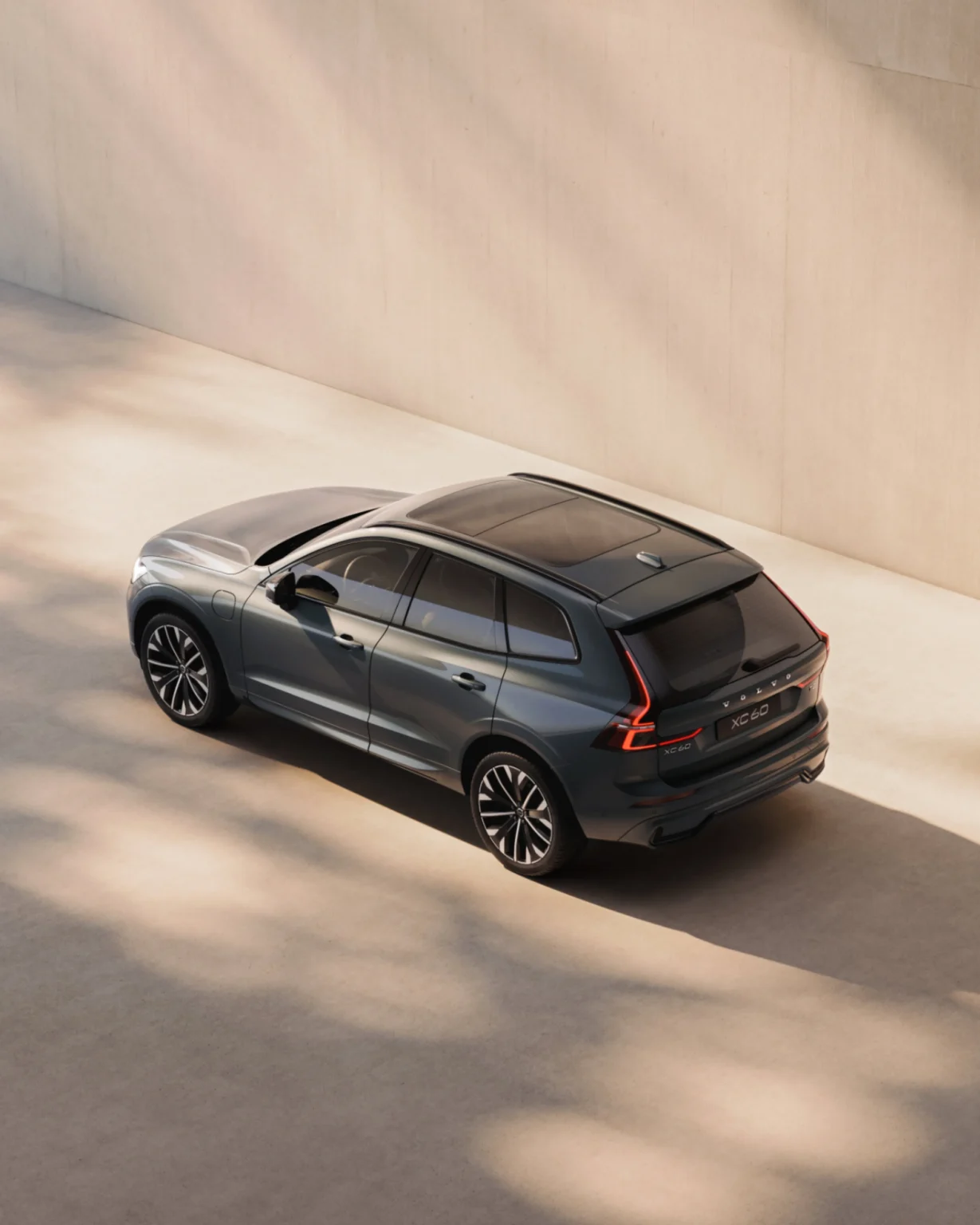 Volvo XC60 from a high rear three-quarter angle, showing its panoramic roof