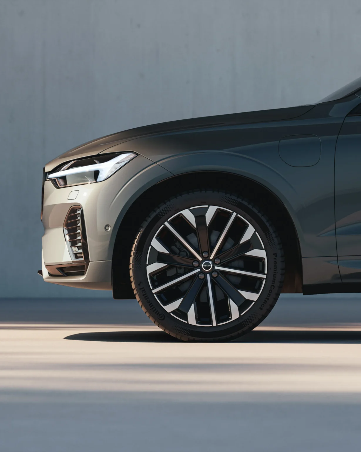 Close-up of the Volvo XC60 front wheel beside a concrete wall