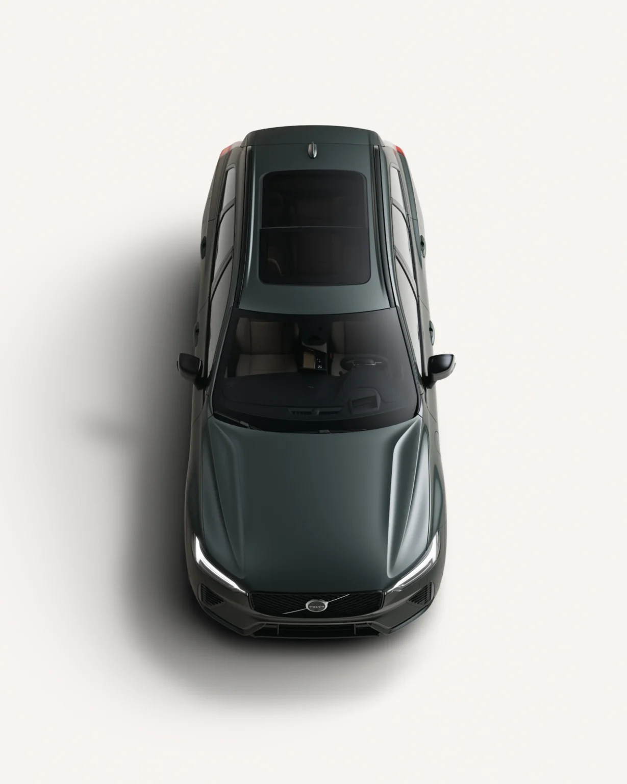 Volvo XC60 Plug-in Hybrid seen from above in a white studio, showing its panoramic roof