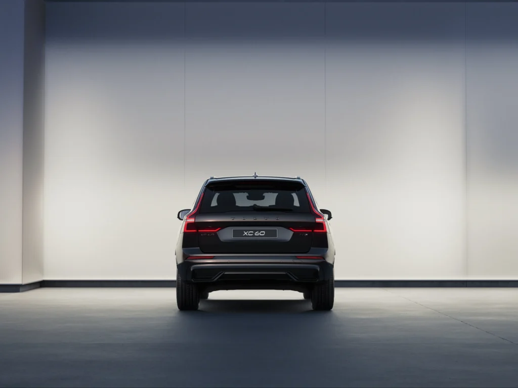 Volvo XC60 Black Edition from behind in a softly lit studio
