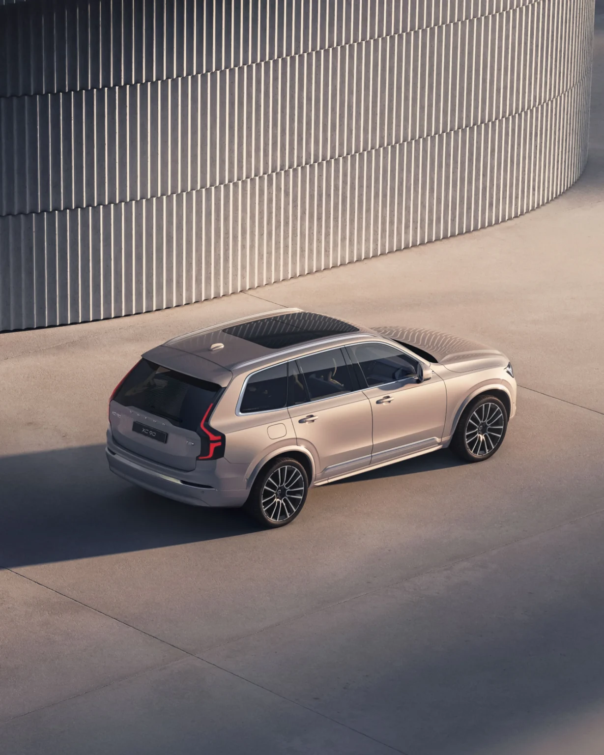 Volvo XC90 from a high rear three-quarter angle, showing its panoramic roof