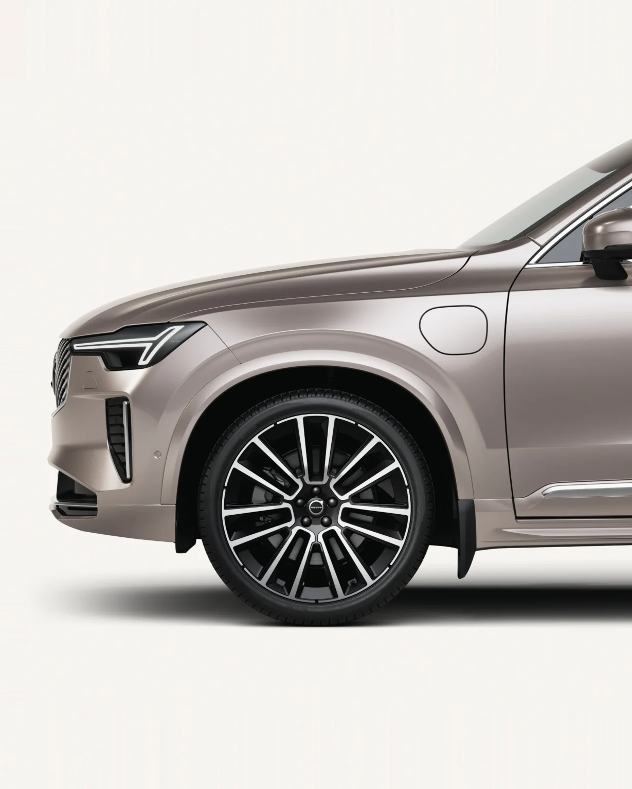 Front half of a Volvo XC90 in a white studio, showing its front wheel